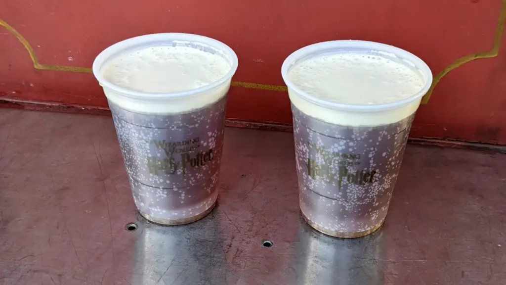 Deux gobelets “Wizarding World of Harry Potter”, remplis à ras bord de bière au beurre. Boisson la plus crémeuse d’Universal Studio.