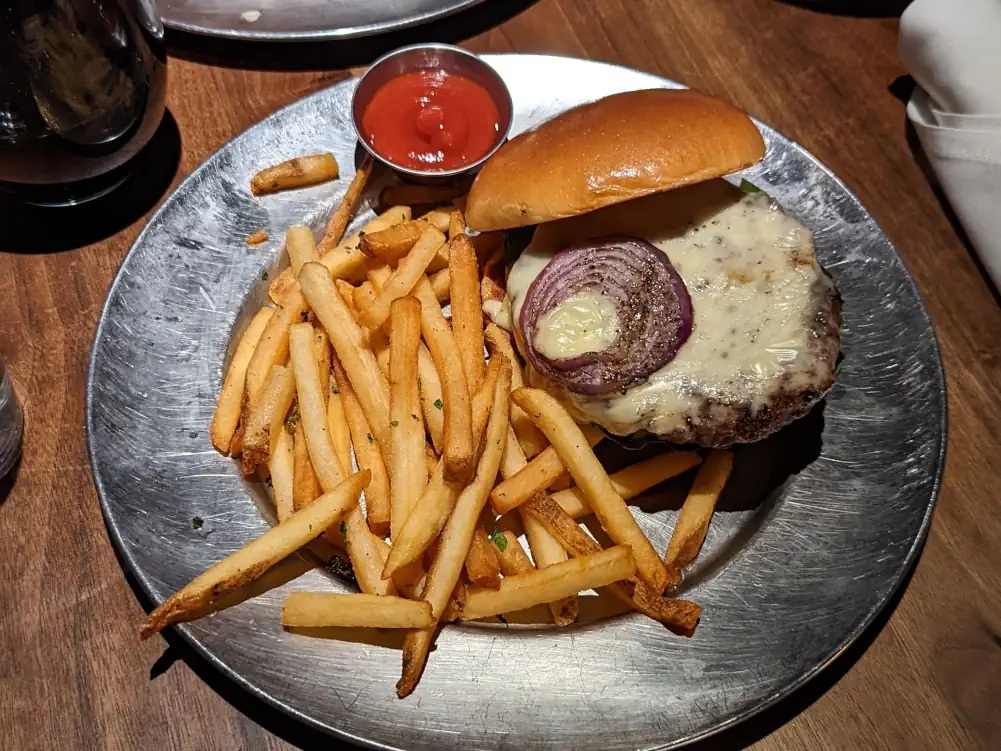 Plat burger du restaurant Eureka! sur Fremont Street. Il est accompagné de fromage, d’une rondelle d’oignon, de frites et d’une sauce rouge.