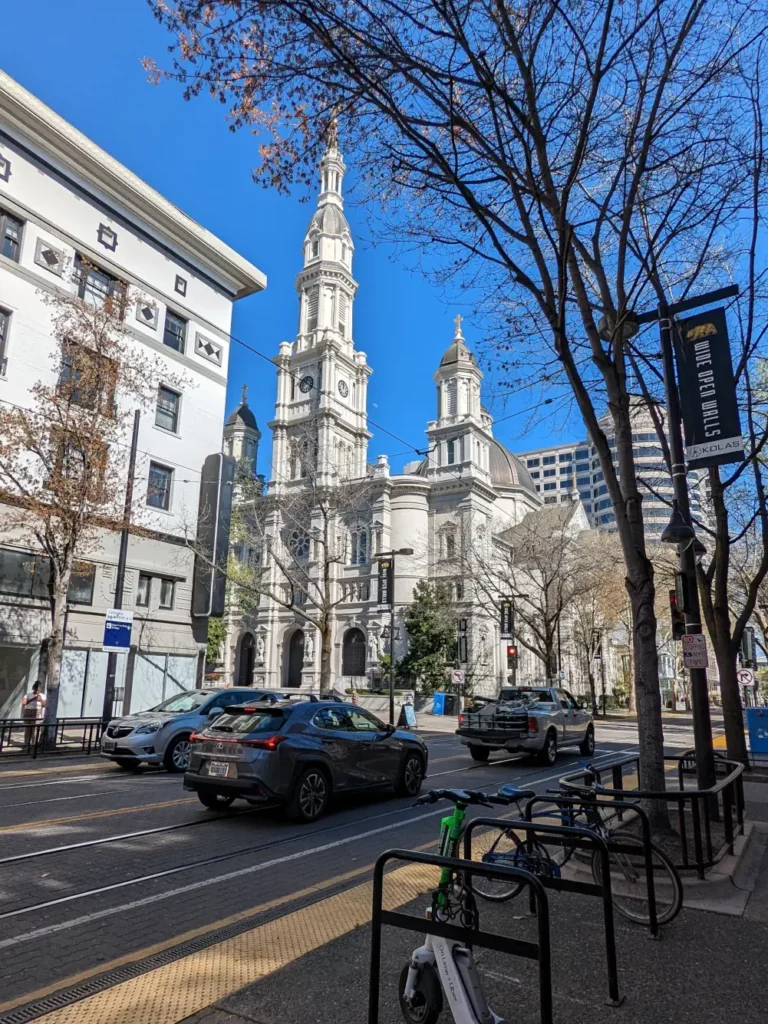 Façade blanche de l’église catholique du Saint-Sacrement, observée depuis la rue de “K St” à Sacramento.