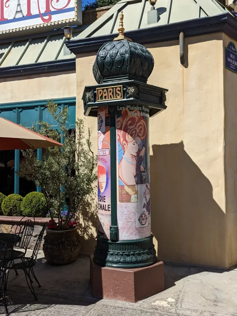 Colonne Morris de plain pied, située dans le quartier français. Sur le dessus, le mot “PARIS” est inscrit en lettres dorées.