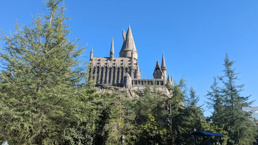 Château de Poudlard, l’un des meilleurs décors du parc Universal Studio à Los Angeles. Il est situé en hauteur, au-dessus des arbres.